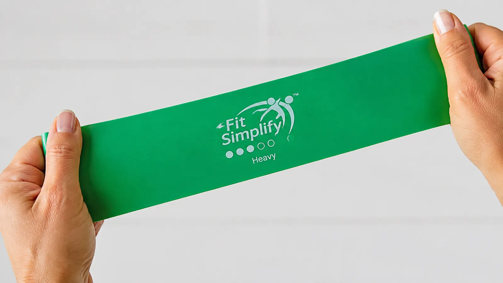 Close-up of a Fit Simplify resistance band being stretched to show the latex texture and thickness